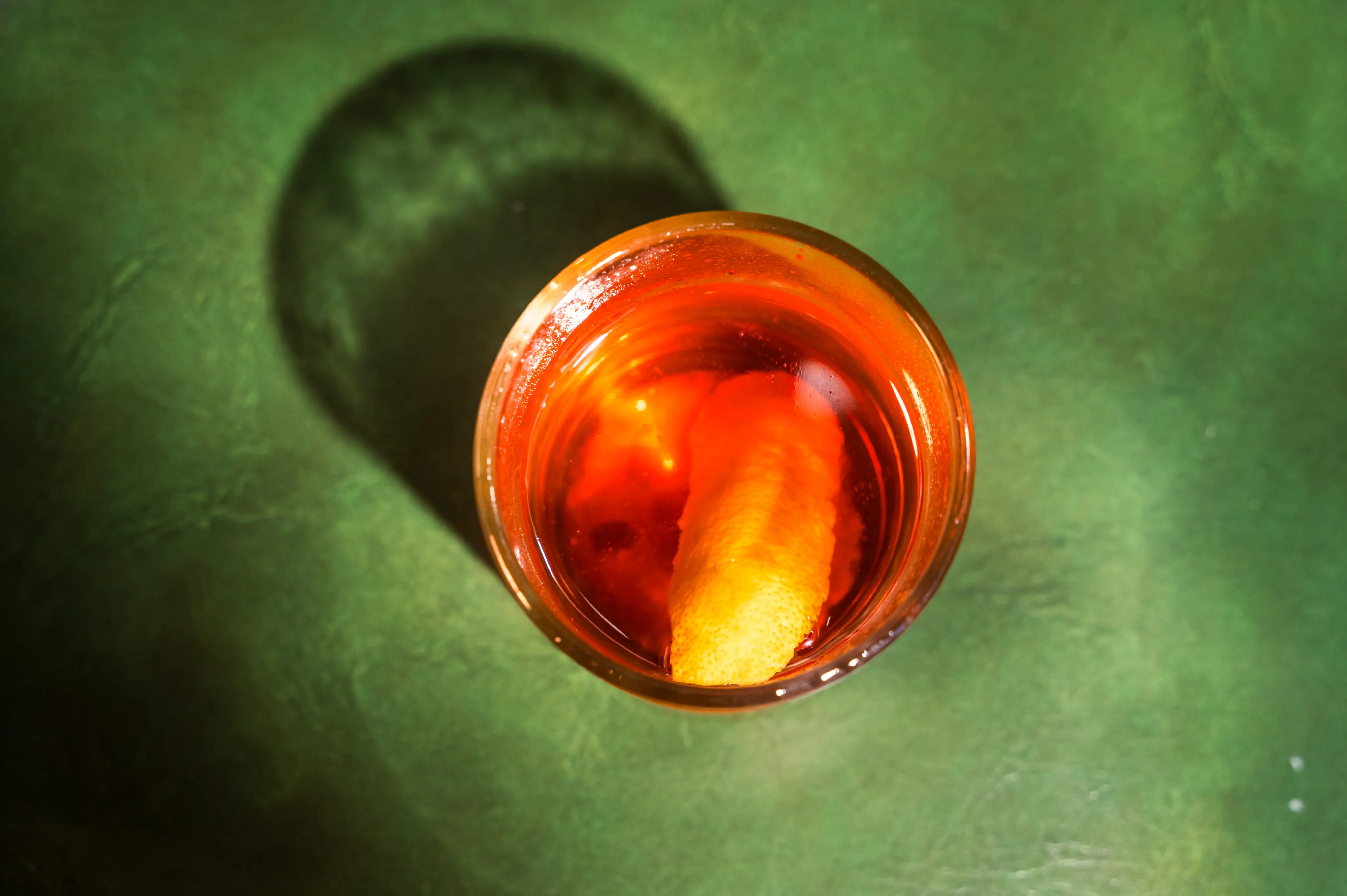 Martini garnish with olives over a coupe glass