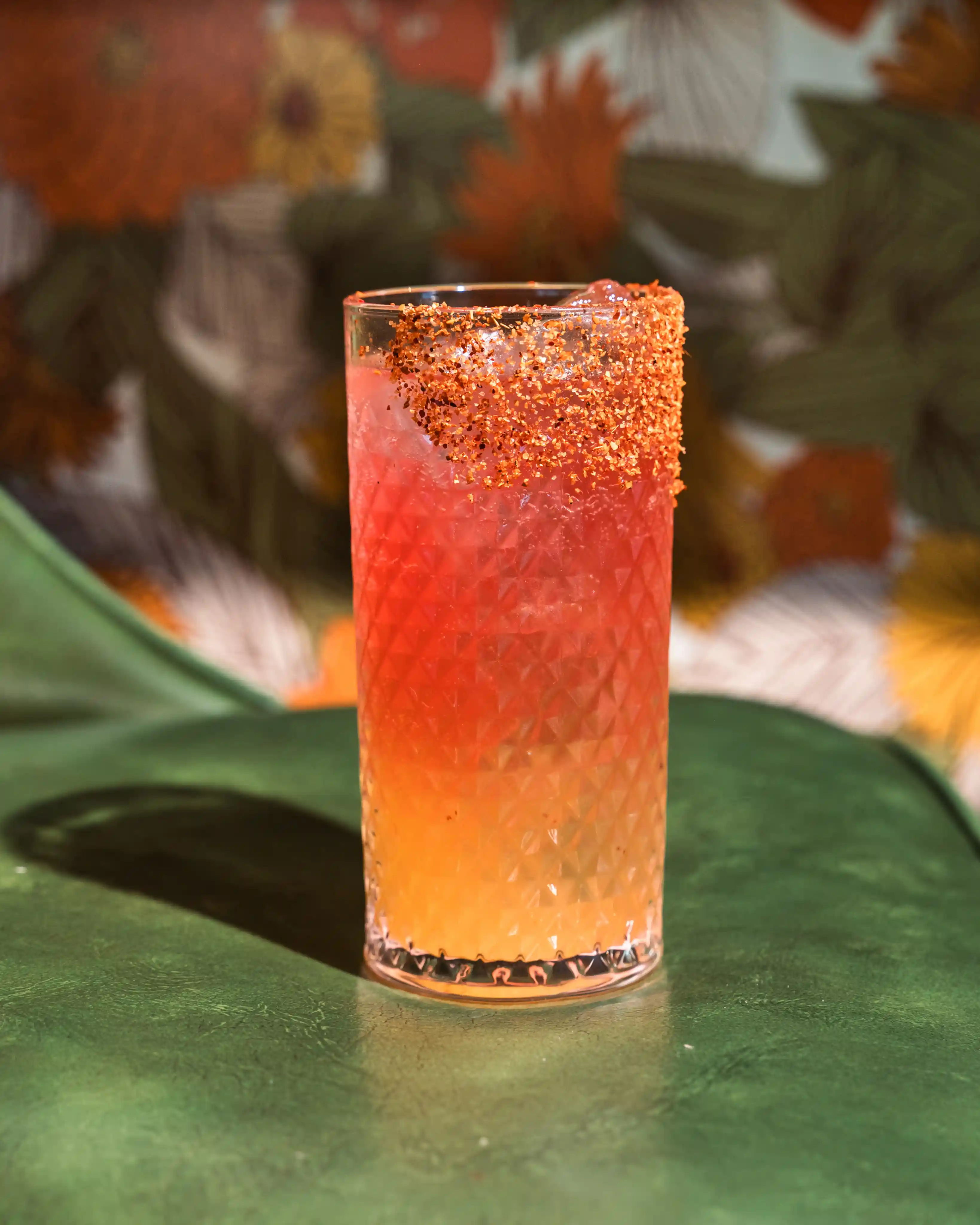 Orange cocktail in a textured glass with spiced rim
