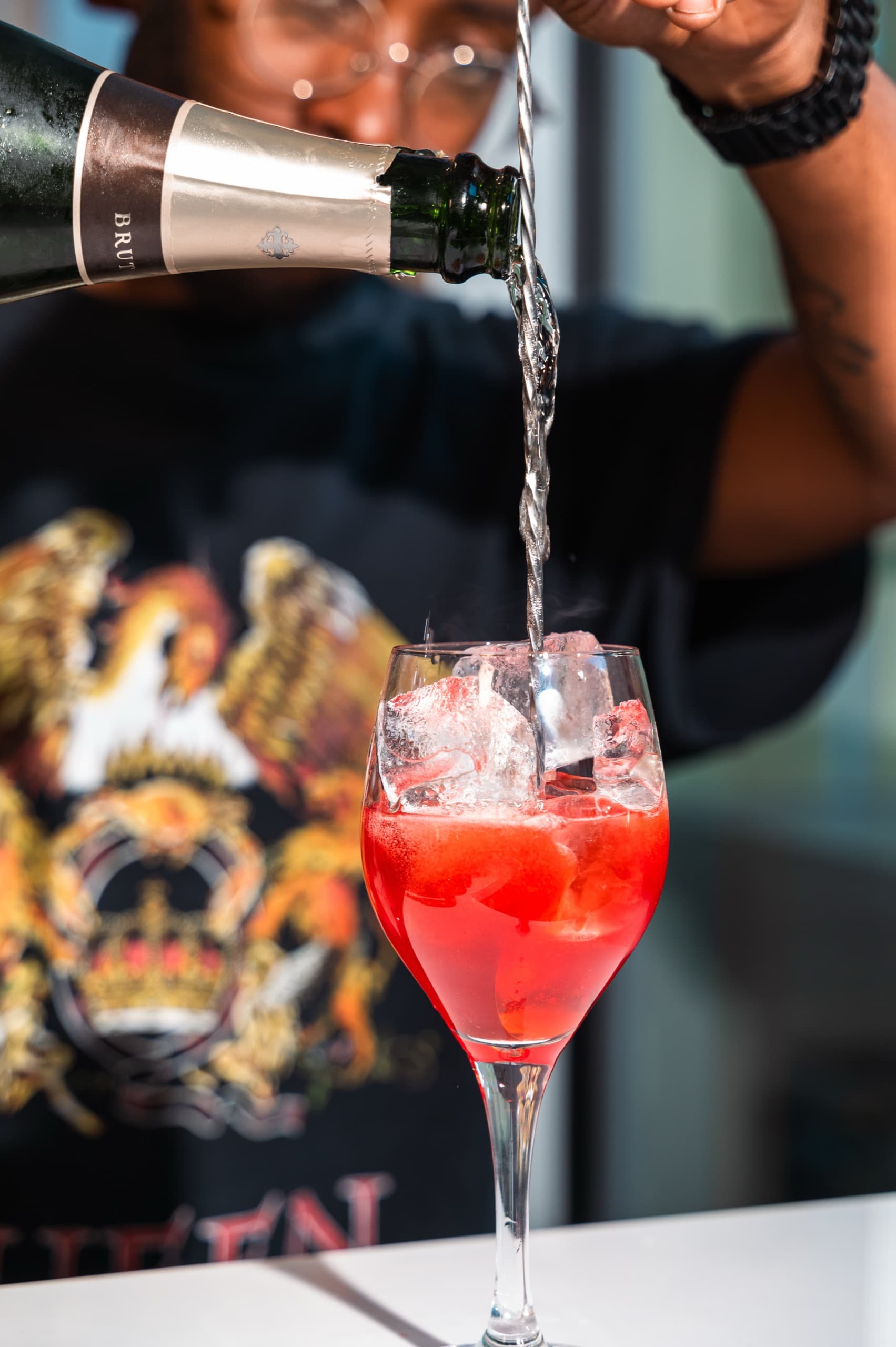 Pouring sparkling wine into a spritz glass