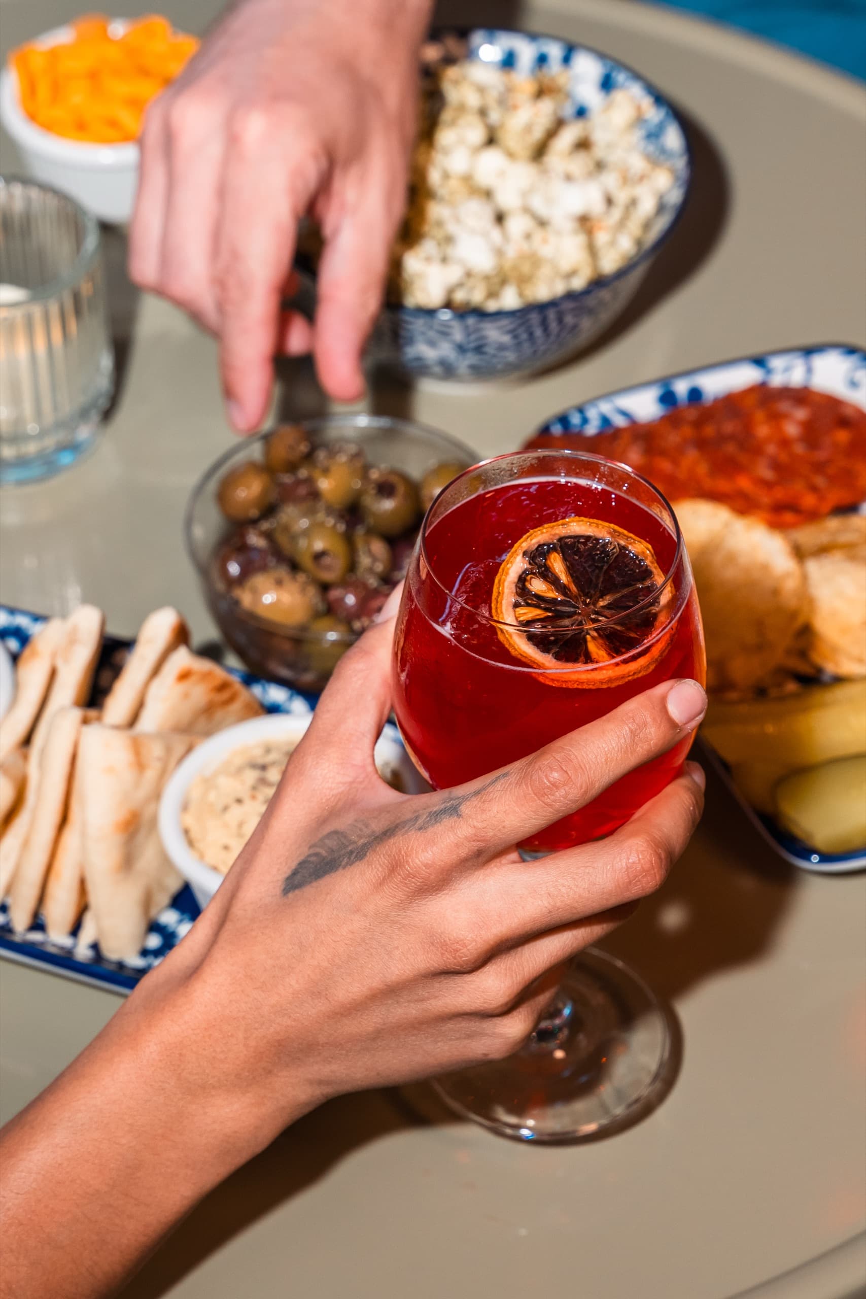 Table spread with cocktails and snacks