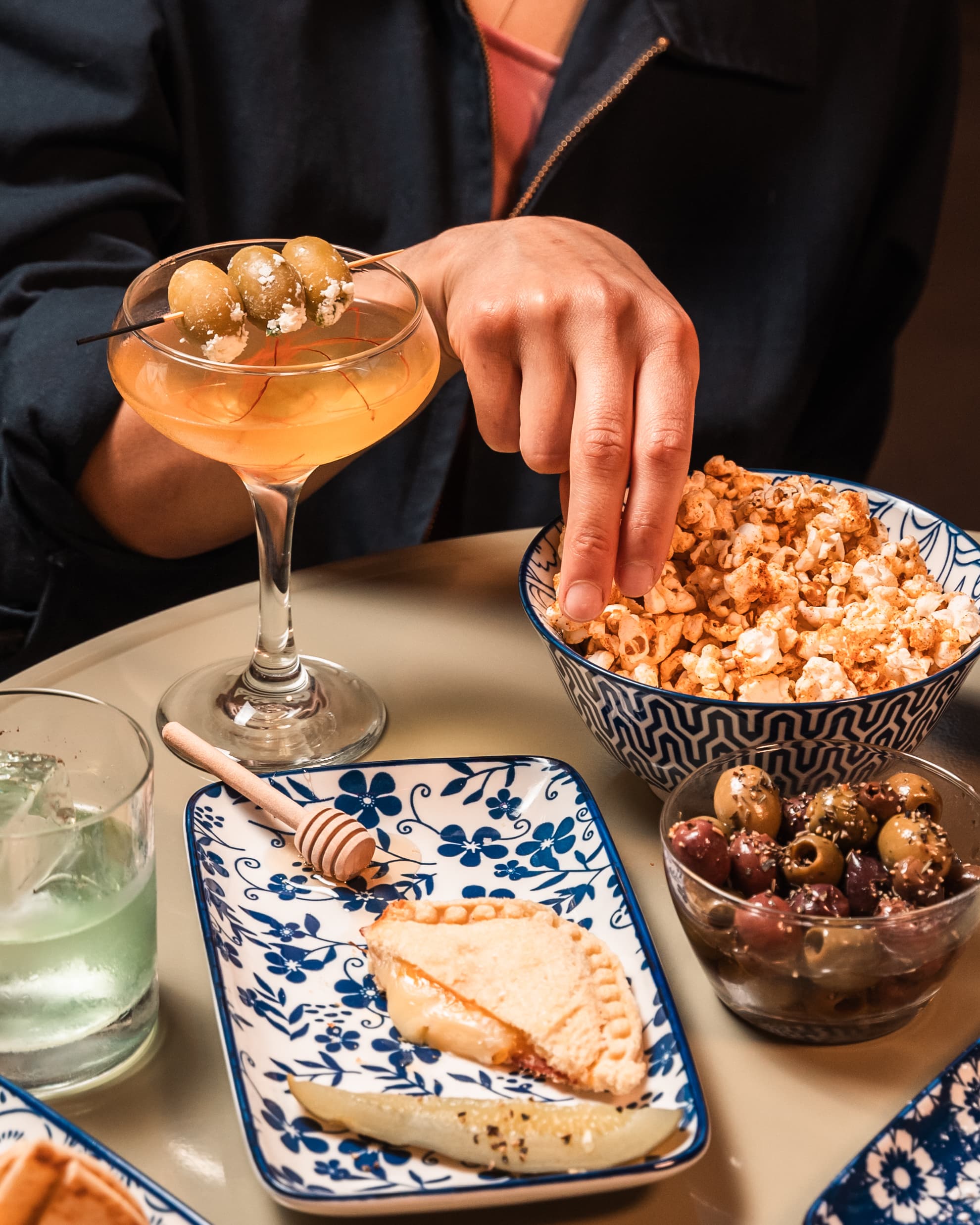 Bar spread with coupe cocktail and appetizers